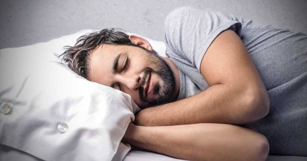 man sleeping on his bed