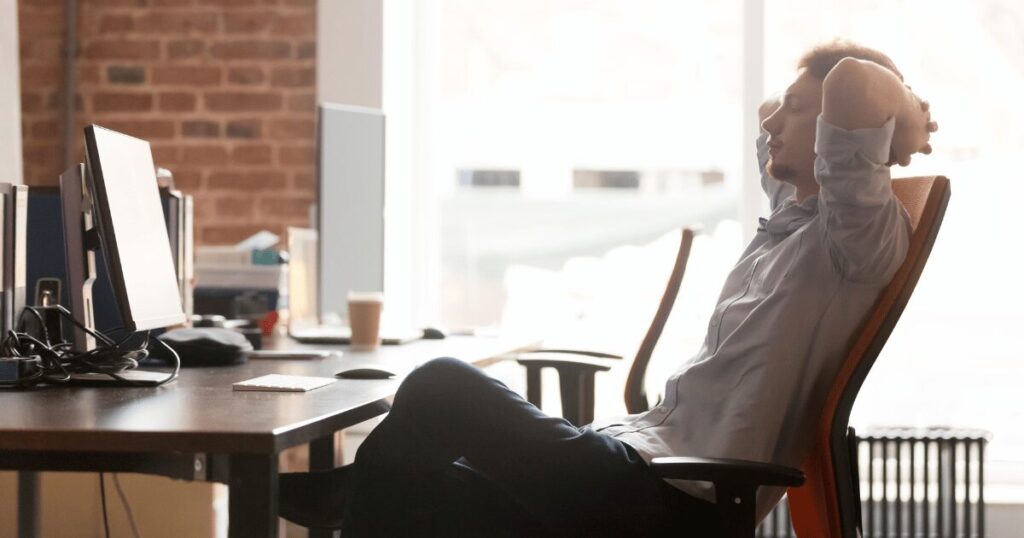 man sitting in ergonomic office setup