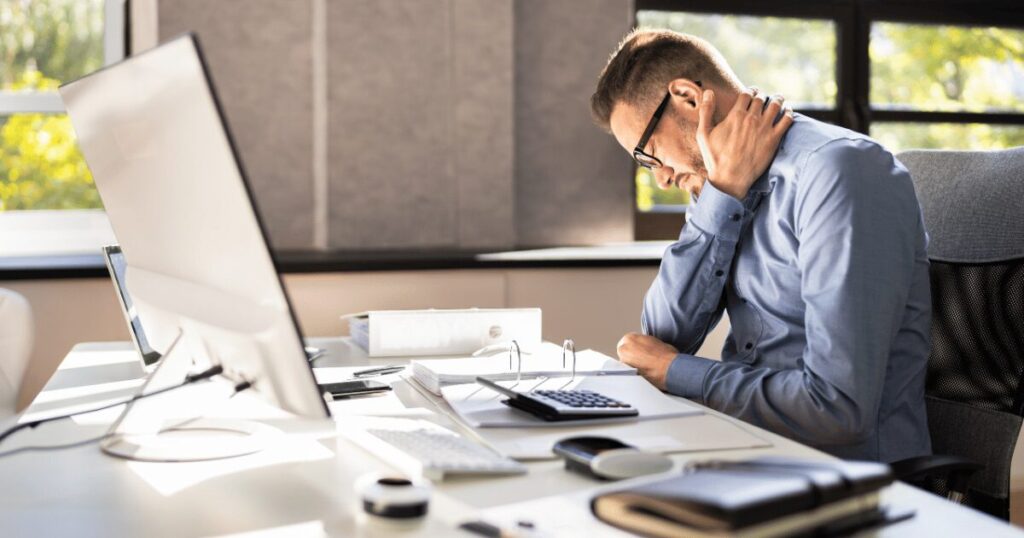 man suffering from neck pain