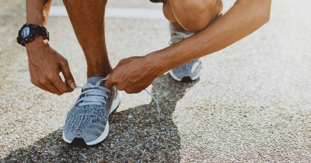 man tying shoes