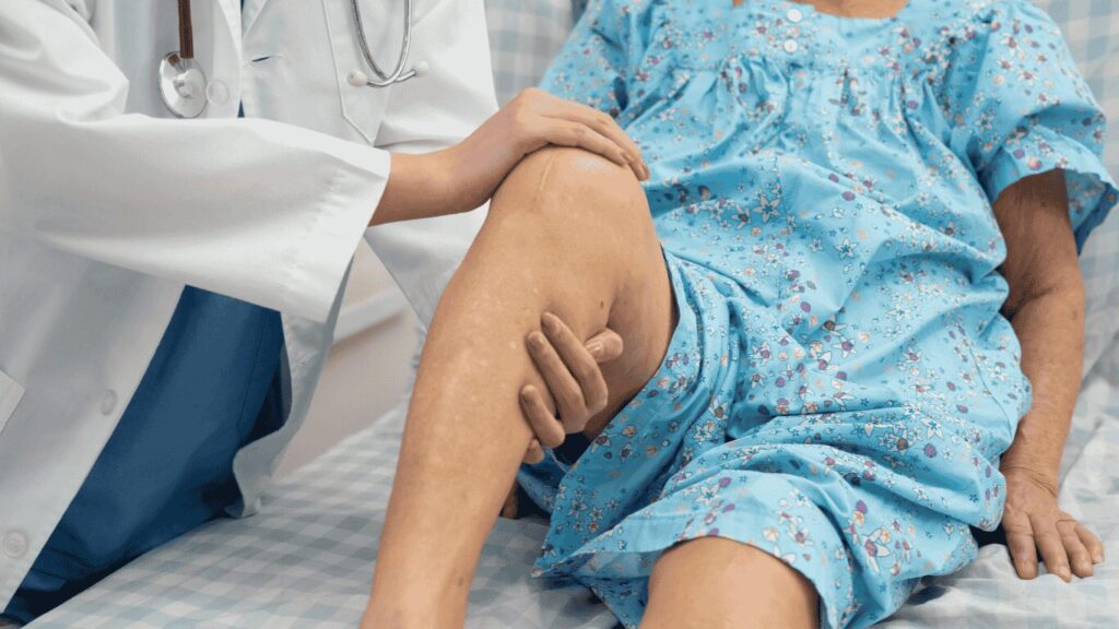 A doctor gently examining a patient's lower leg during a medical checkup
