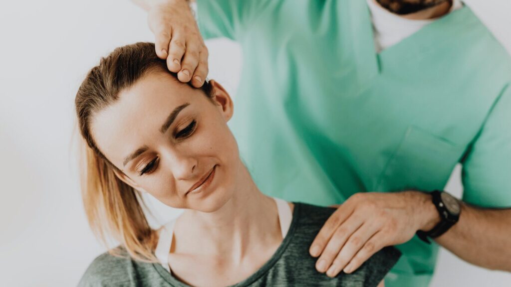 doctor stretching and checking a patient's neck